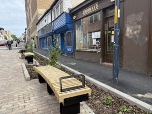 New timber benches and planted rain garden beside a Maidstone town-centre pavement